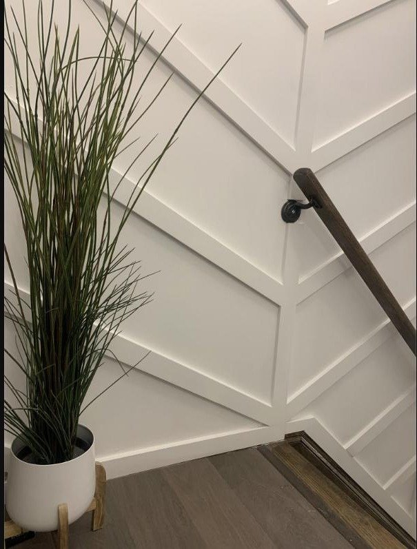 Board-and-batten wall panelling and stair trim installed by 404 Renovation Team